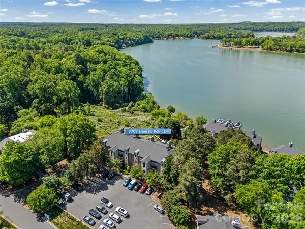 an aerial view of a houses with a lake view