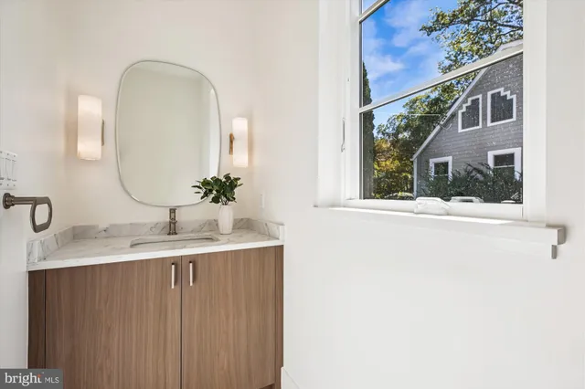 a bedroom with a bed and large windows