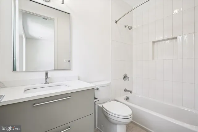 a view of an empty room with wooden floor and stairs