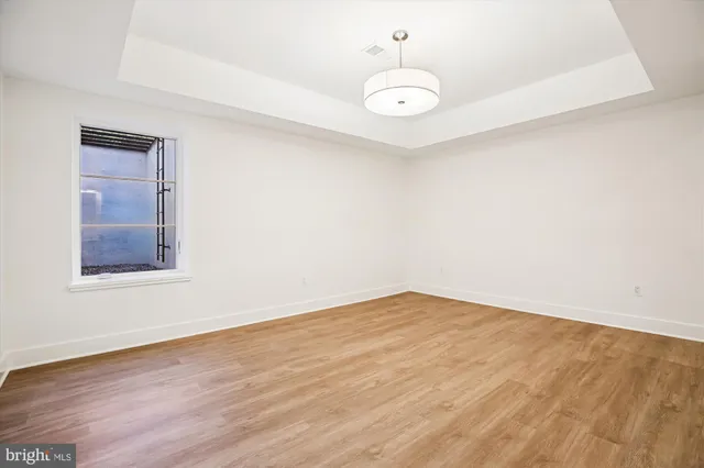 a view of empty room with wooden floor