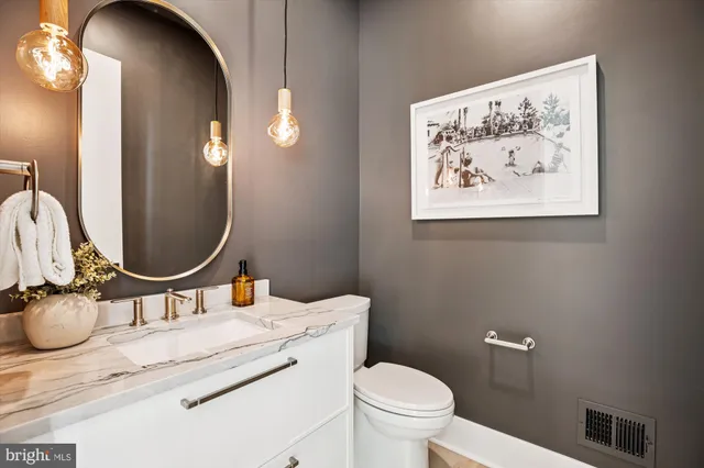a kitchen with cabinets a sink and stainless steel appliances