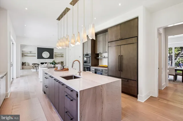 a kitchen with counter top space a sink appliances and cabinets