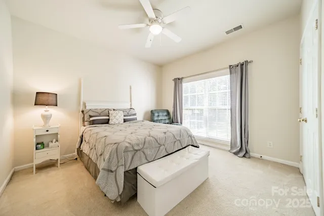 a spacious bedroom with a bed and window