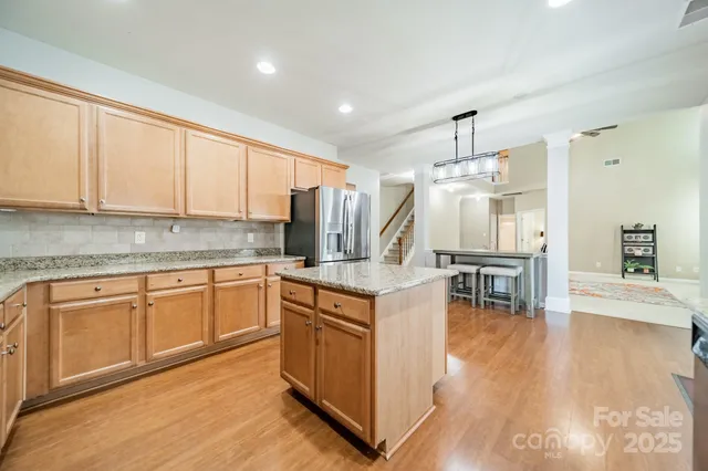 a kitchen with a sink cabinets and wooden floor