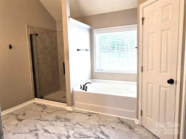 a bathroom with a bathtub and a shower