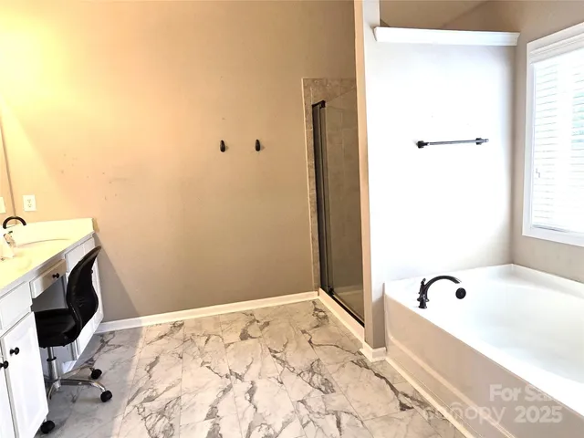 a bathroom with a bathtub and a sink