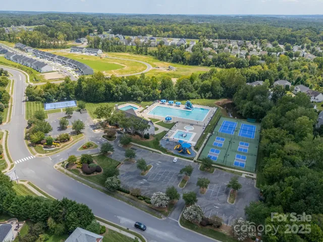 an aerial view of residential houses with outdoor space and river