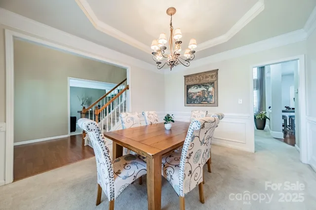 a view of a dining room with furniture and chandelier
