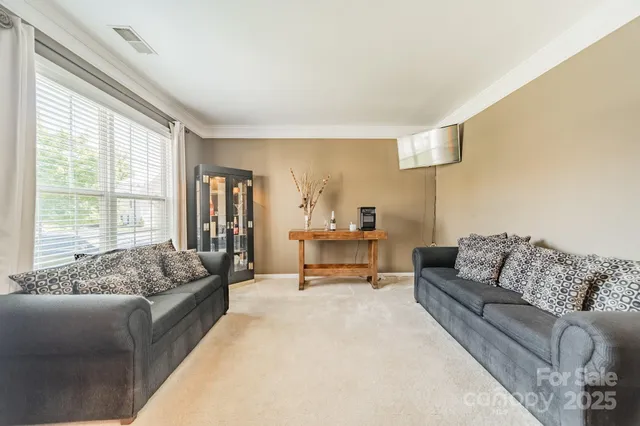 a spacious bedroom with a bed couch and windows