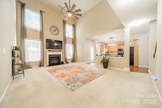 a living room with stainless steel appliances kitchen island furniture and a flat screen tv