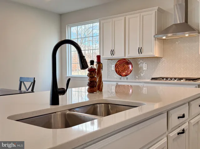 a view of a closet area with ceiling fan