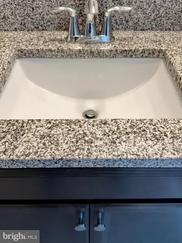 a bathroom with double sink and a mirror