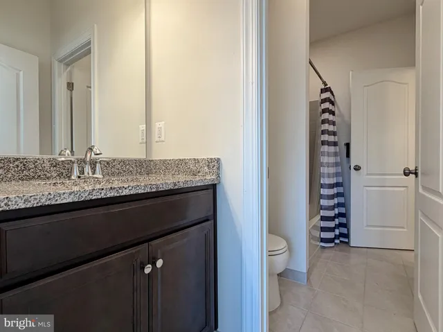 a large bedroom with a bed and window