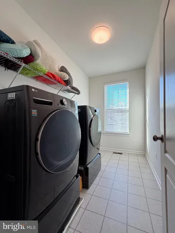 a front view of a house with garden and sitting area
