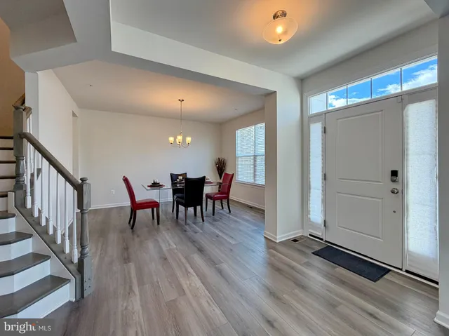 a view of an entryway with wooden floor and stairs