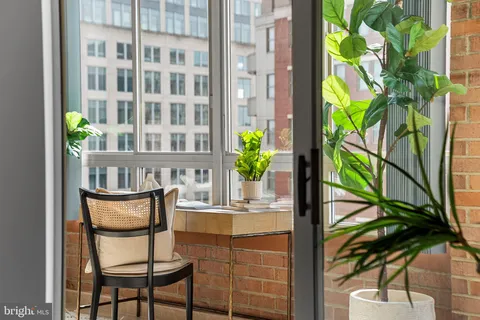 a view of a chairs and table in a balcony