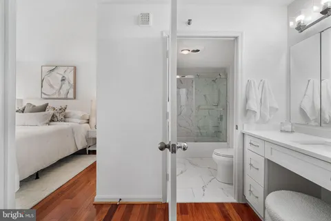 a bathroom with a granite countertop sink toilet and shower