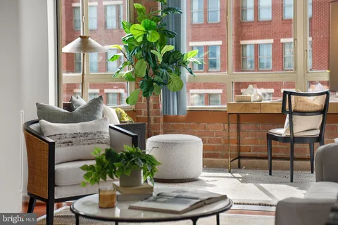 a vase of flowers sitting on a table with a potted plant