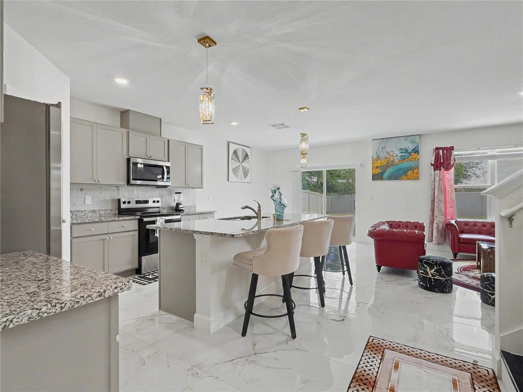 2085 Doe Run Drive Davenport, FL 33837 - Photo 12 of 44 a kitchen with a sink cabinets and window