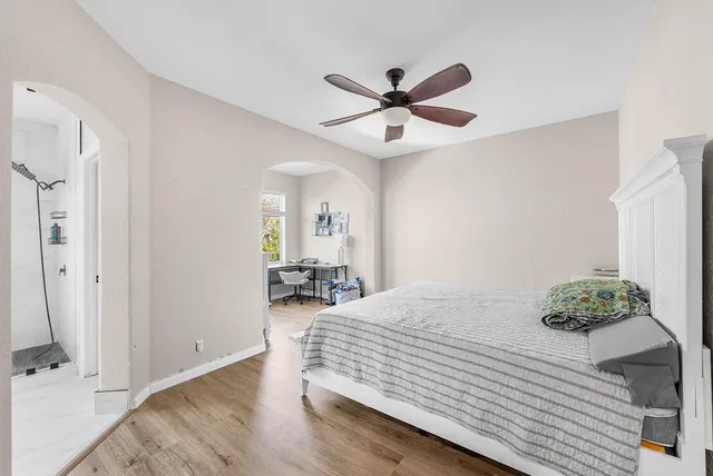 a bedroom with a bed and a chandelier