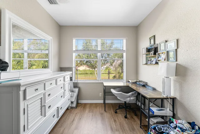 a view of a workspace with furniture and a window