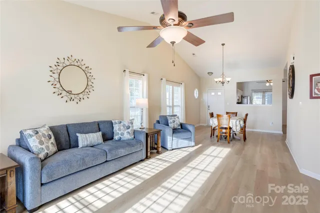 a living room with furniture and kitchen view