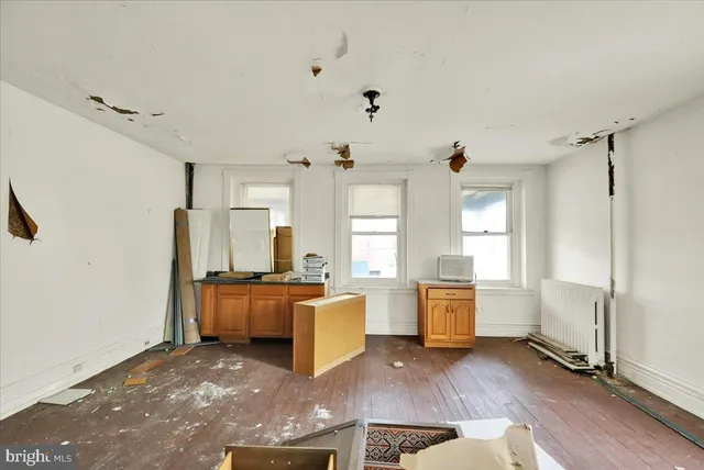 a living room with fireplace furniture and a window