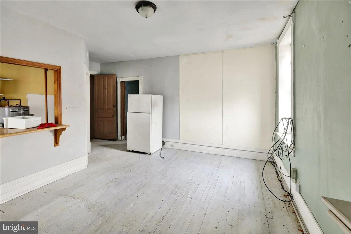 200 West Lancaster Avenue Reading, PA 19607 - Photo 45 of 50 an empty room with wooden floor and windows