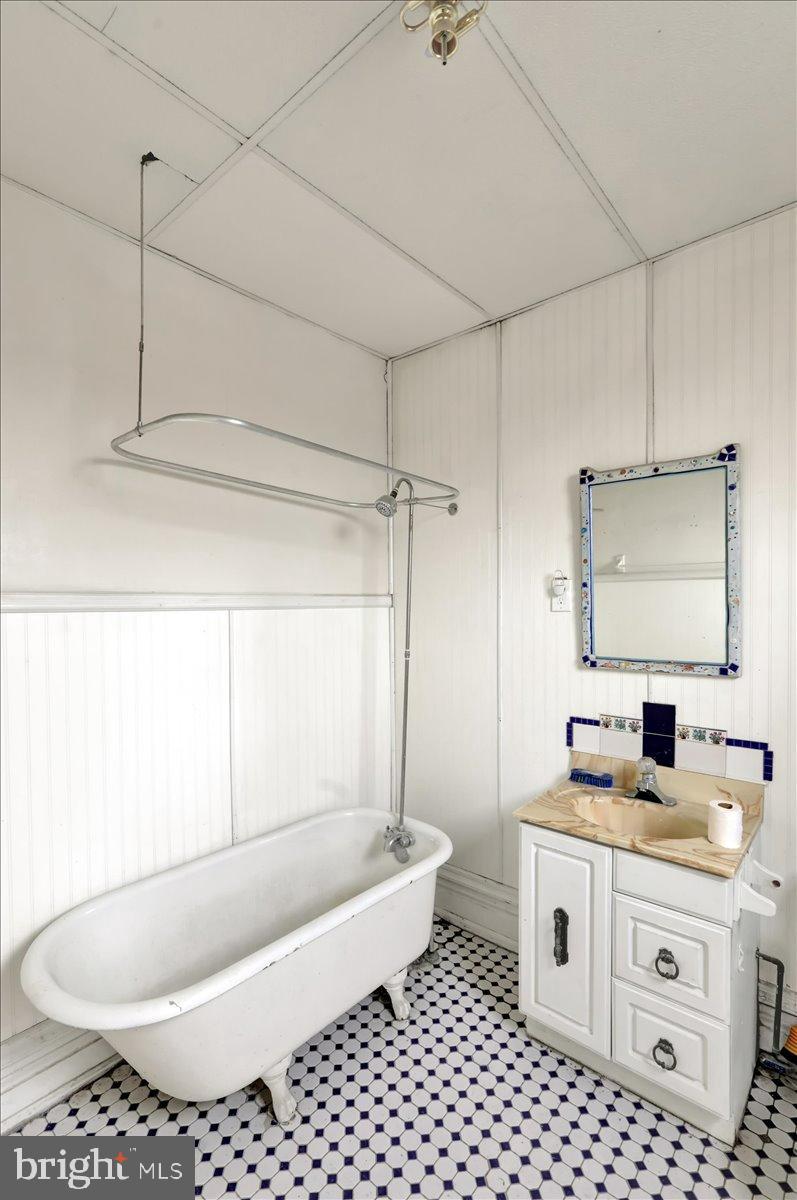 200 West Lancaster Avenue Reading, PA 19607 - Photo 47 of 50 a bathroom with a granite countertop sink a toilet a mirror a bathtub and shower