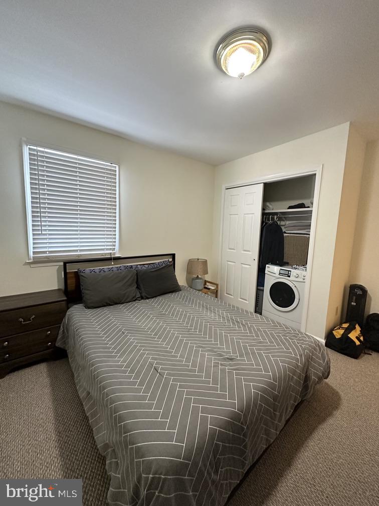 29 West State Street, Unit 1 Doylestown, PA 18901 - Photo 5 of 7 a bedroom with a bed and a large window