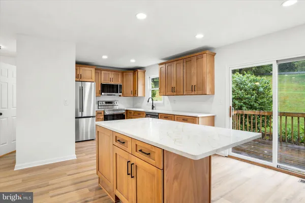 a kitchen with a sink a stove a refrigerator and a cabinets