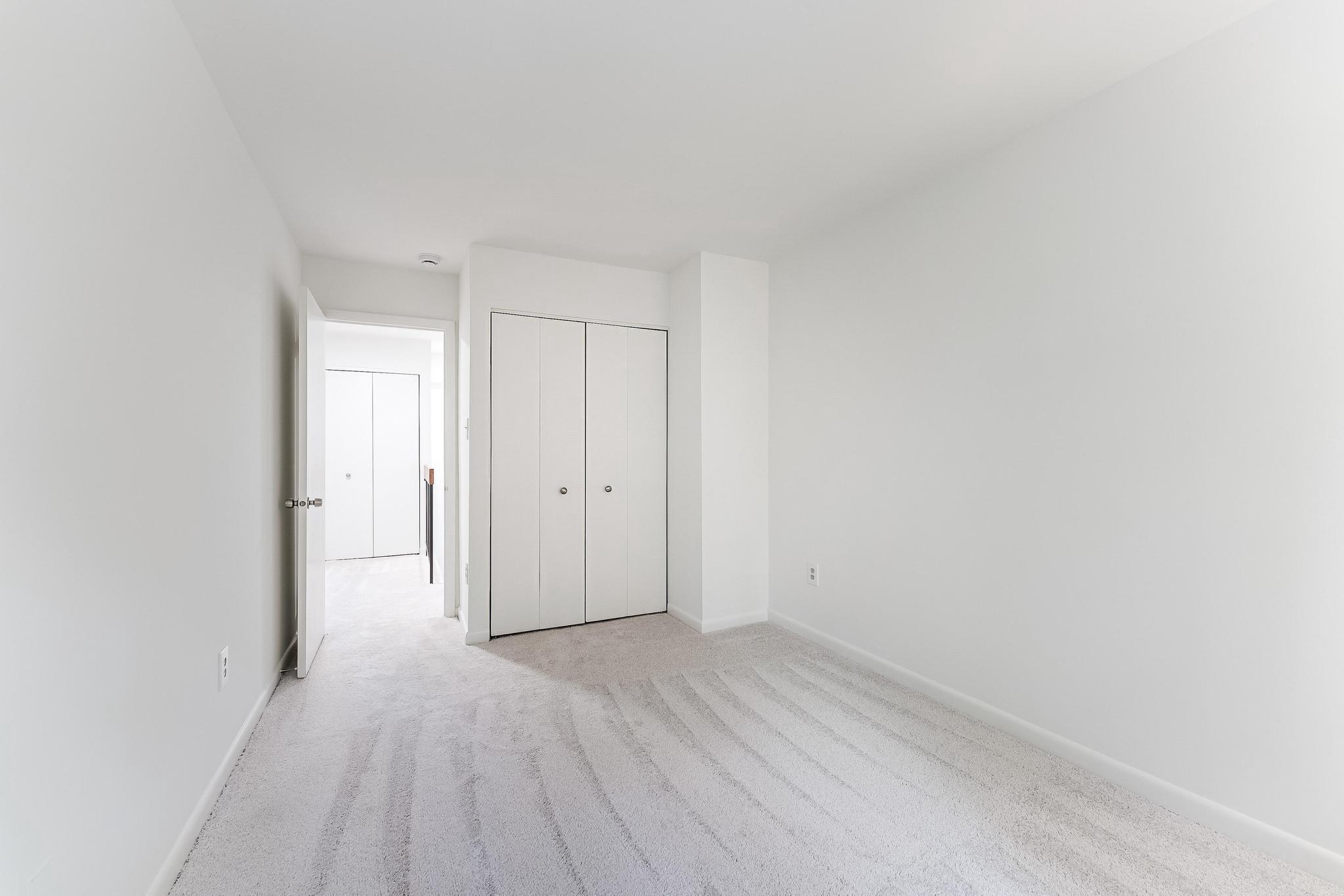 12023 Insha Court Reston, VA 20191 - Photo 41 of 52 a view of a room with wooden floor and white doors