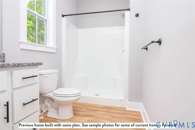 a bathroom with a toilet and a shower