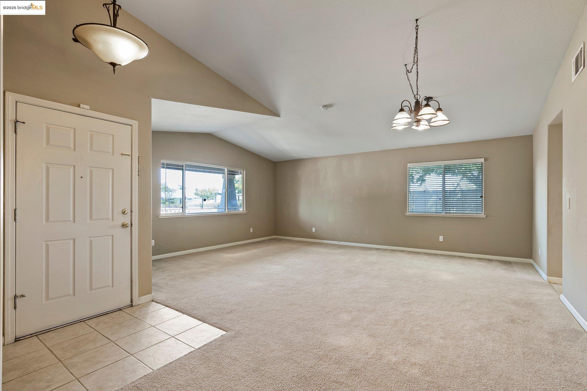 5200 Mohican Way Antioch, CA 94531 - Photo 44 of 50 an empty room with windows and chandelier fan