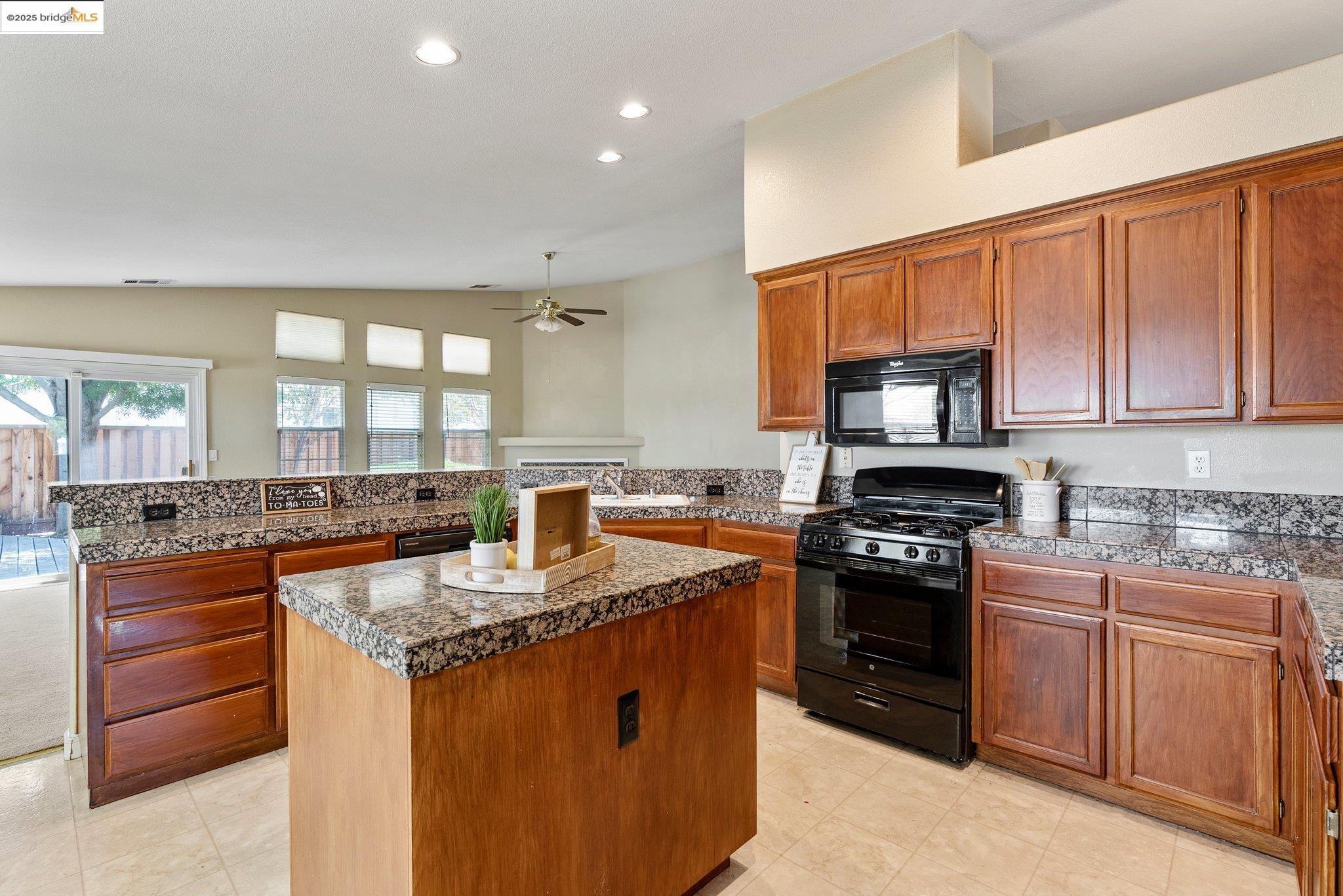 5200 Mohican Way Antioch, CA 94531 - Photo 10 of 50 a kitchen with stainless steel appliances granite countertop a stove top oven a sink dishwasher a dining table and chairs with wooden floor