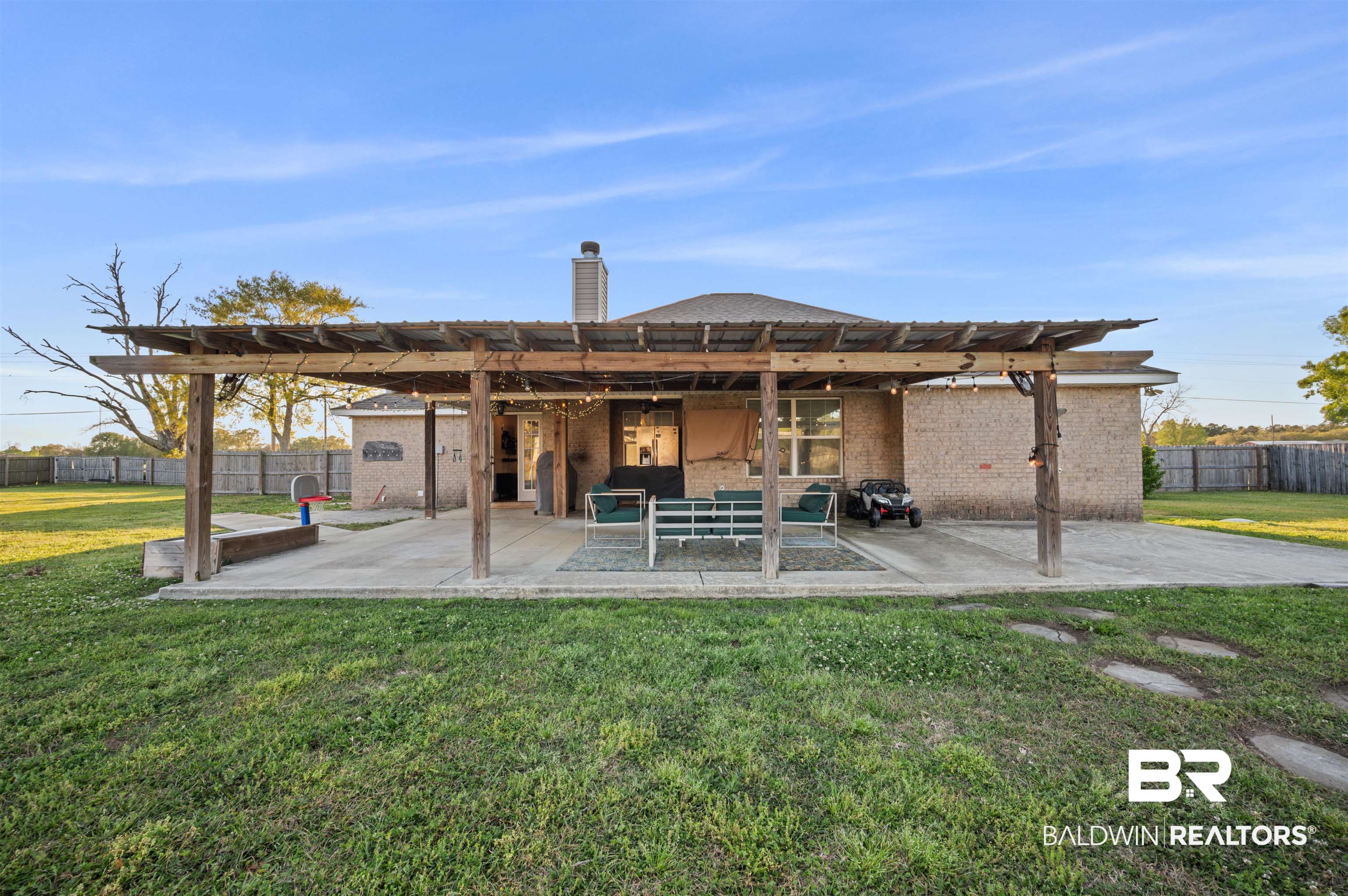 22370 Buck Road Robertsdale, AL 36567 - Photo 21 of 31 Back of house with a yard, a pergola, fence, and a patio area