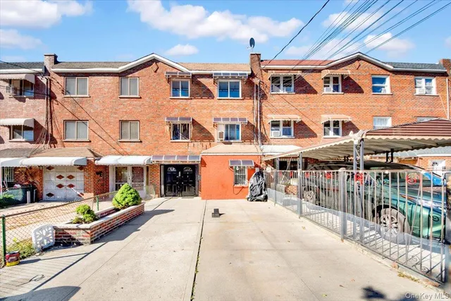 a front view of a building with a garden