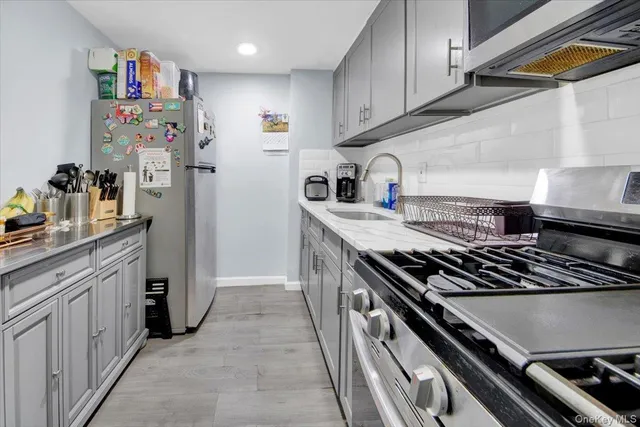 a kitchen with stainless steel appliances granite countertop a stove and a refrigerator
