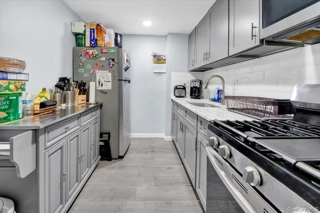a kitchen with stainless steel appliances granite countertop a sink stove and refrigerator