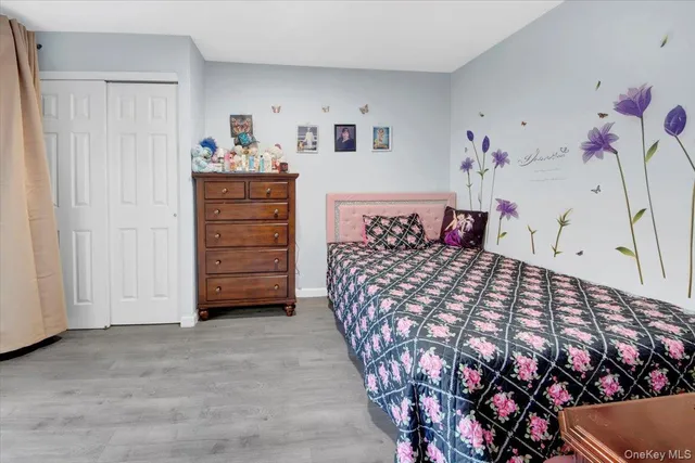 a view of a hallway with wooden floor and windows