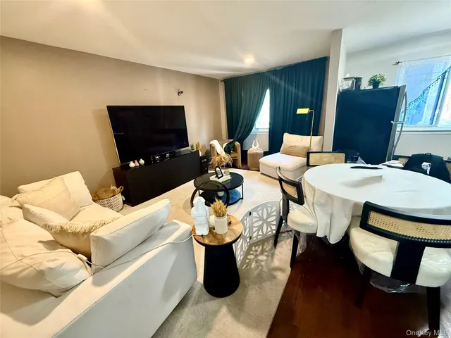 a kitchen with stainless steel appliances granite countertop a sink a stove a refrigerator counter space and wooden floor