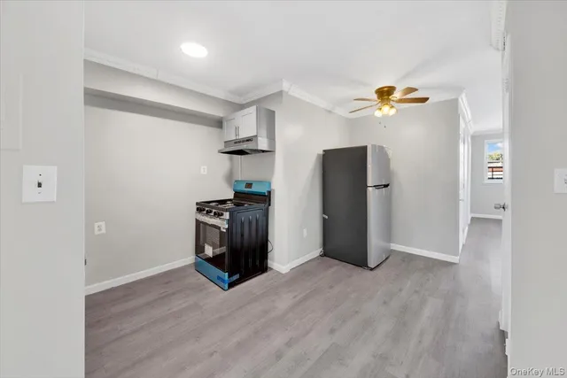 an empty room with wooden floor and entrance