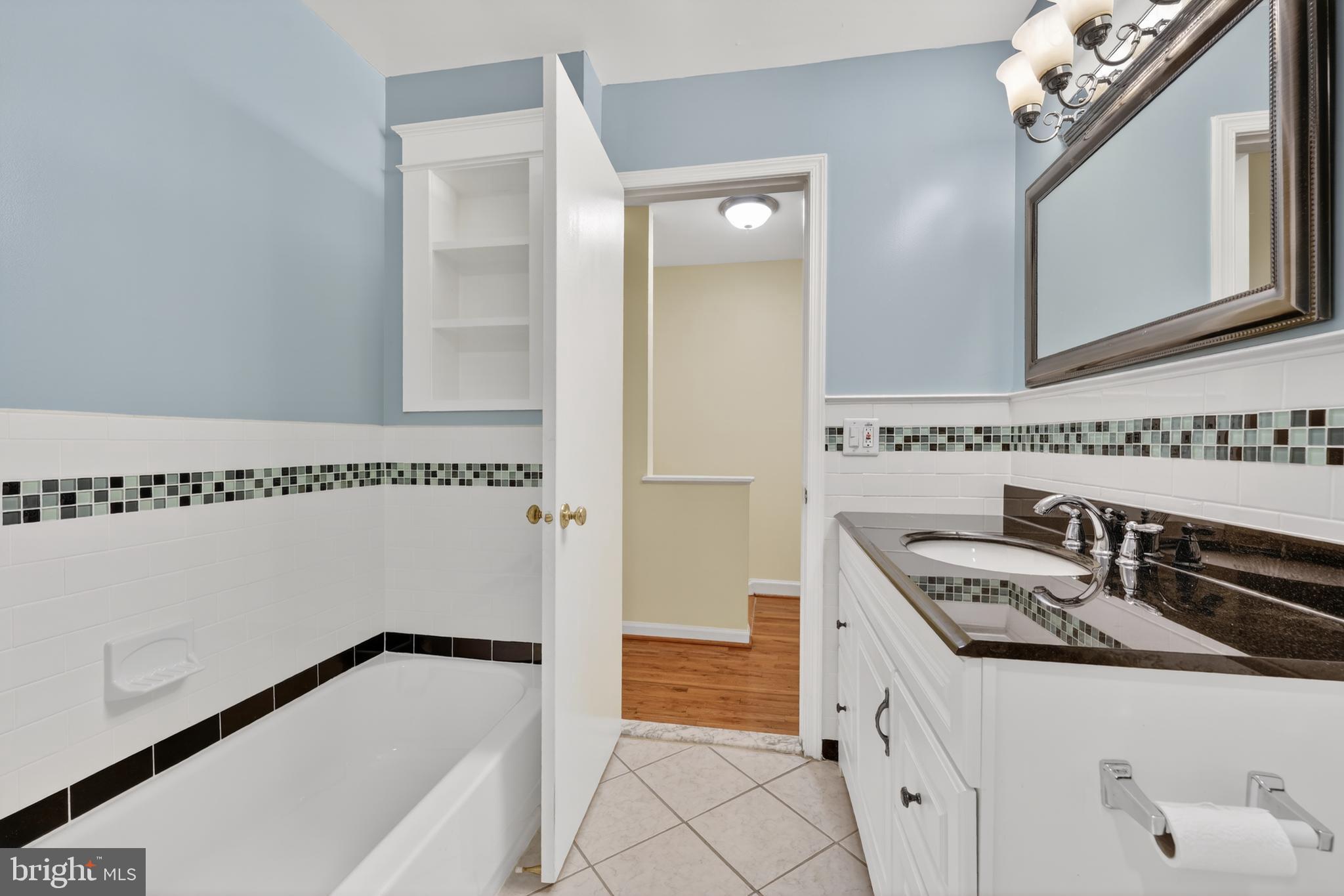 8139 Carrleigh Parkway Springfield, VA 22152 - Photo 19 of 27 a bathroom with a sink and a mirror