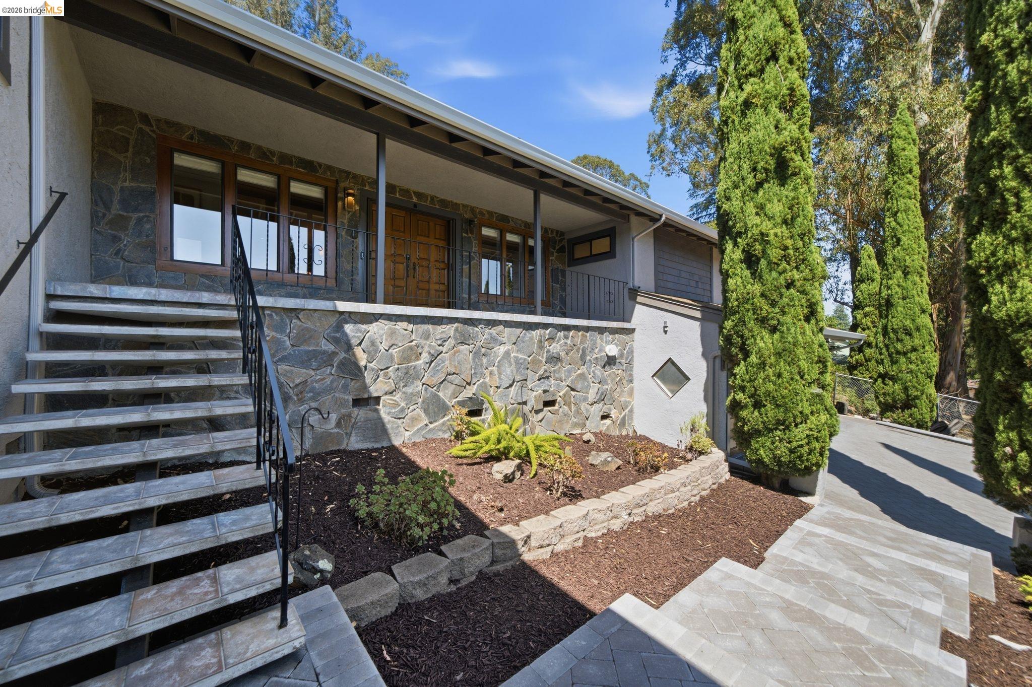 11133 Golf Links Road Oakland, CA 94605 - Photo 6 of 57 Stone veneer facade featuring a covered porch entry