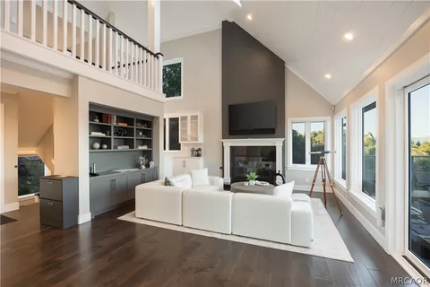 a living room with furniture fireplace and flat screen tv