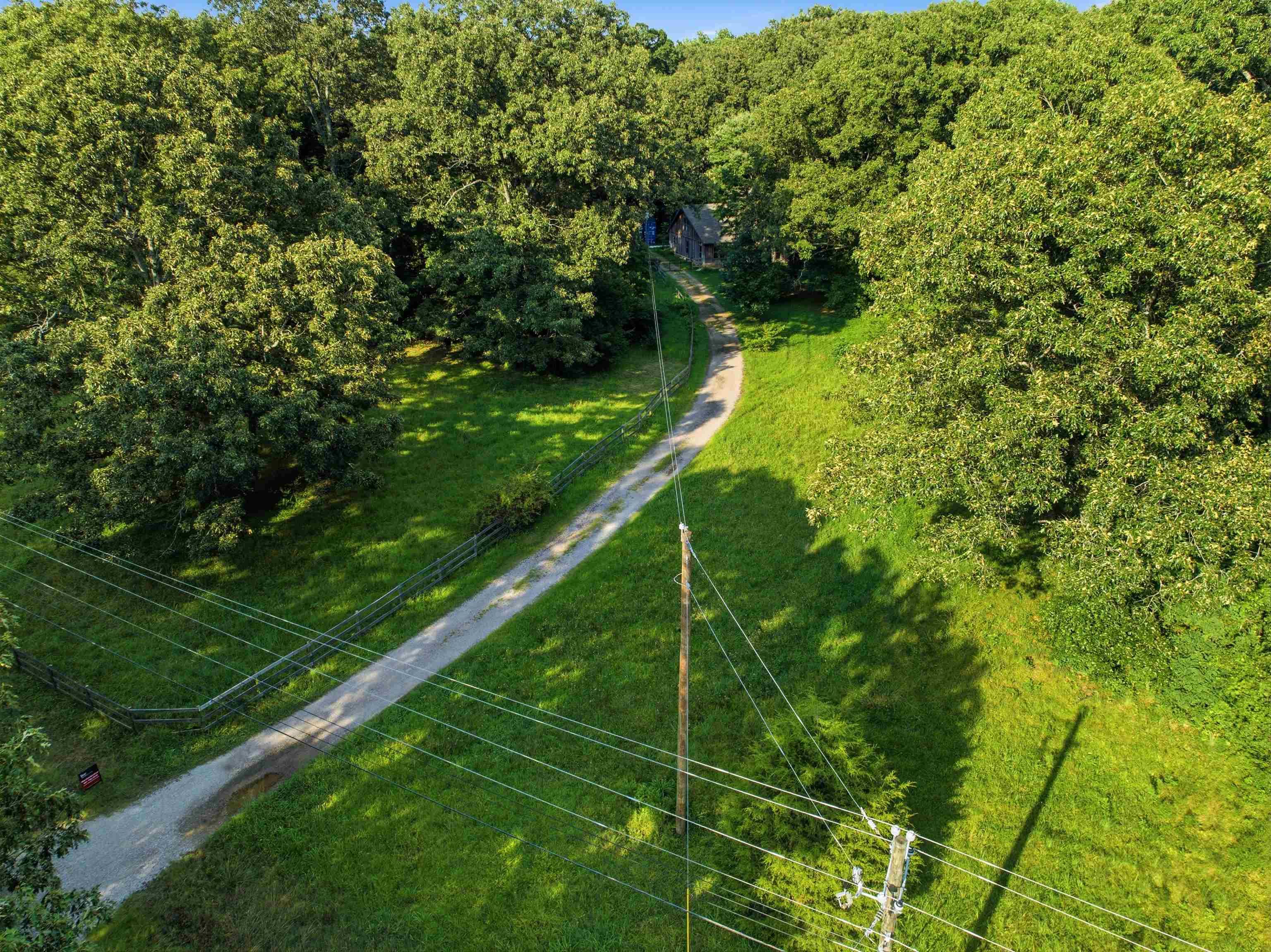 7320 McKinstry Road Moscow, TN 38057 - Photo 37 of 40 A winding private drive welcomes you home, offering exceptional privacy amid mature trees and open green space. A picturesque setting that feels secluded while providing easy access to everyday conveniences.