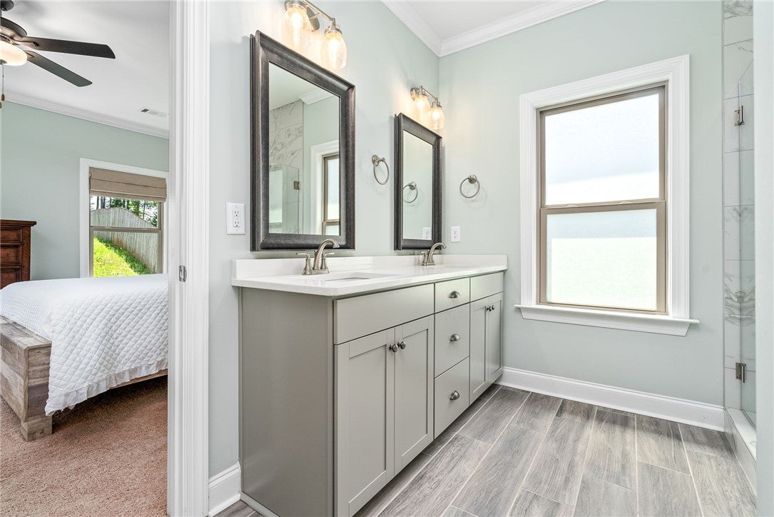 3053 Mimms Trl Road Auburn, AL 36832 - Photo 14 of 45 The primary bath features an elongated vanity with two sinks, a frameless floor-to-ceiling tile shower, a full-size window, a water closet, & a tremendous closet.