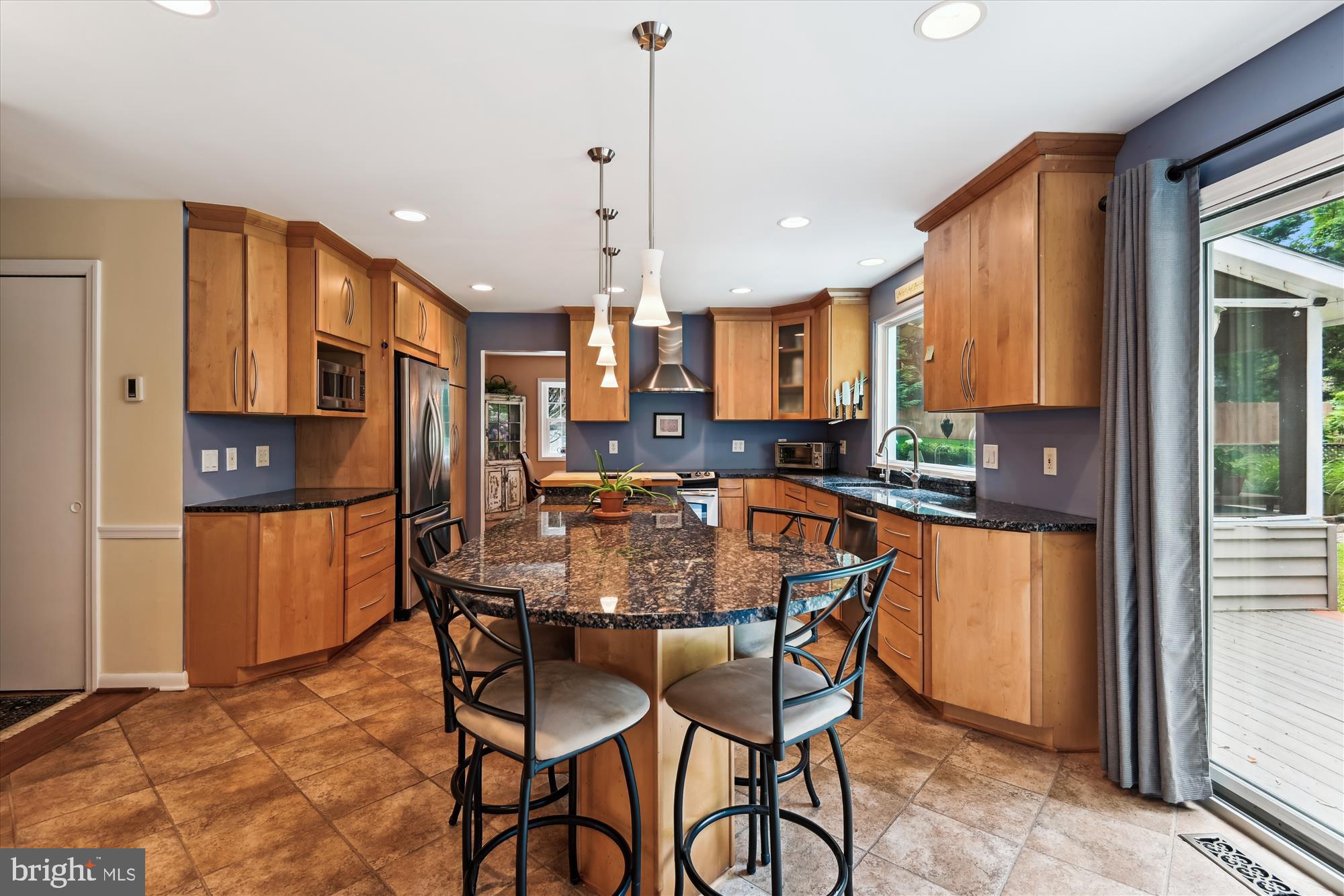 2104 Harbor Drive Annapolis, MD 21409 - Photo 12 of 86 a kitchen with stainless steel appliances granite countertop a kitchen island a stove a refrigerator a sink a dining table and chairs with wooden floor