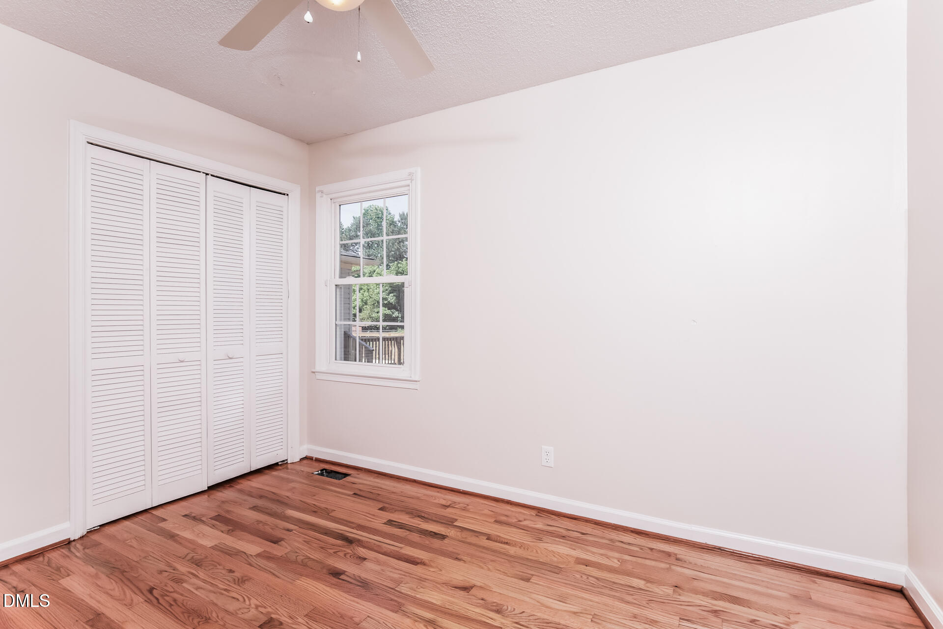 870 Abbott Road Henderson, NC 27537 - Photo 18 of 20 an empty room with wooden floor and windows