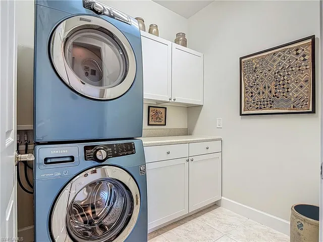 a utility room with sink dryer and washer